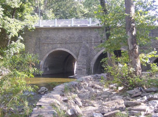 The stone arch bridge on Frankford Avenue in Holmesburg, Philadelphia, Pennsylvania. Erected in 1697 in the Holmesburg section of Northeast Philadelphia, in the U.S. state of Pennsylvania, it is the oldest surviving roadway bridge in the United States.