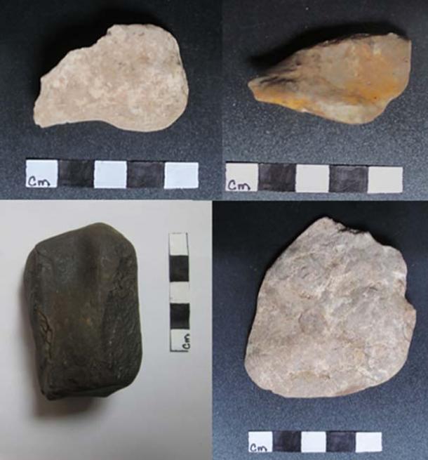 Three possible stone tools and one of the soft black rocks found in one of the caves.