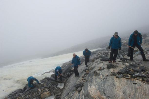 A systematic survey along the upper edge of the Lendbreen ice patch in 2011, where numerous medieval artifacts have been exposed to archaeologists and historians as the ice melts more and more. (Johan Wildhagen / Palookaville / Secrets of the Ice)