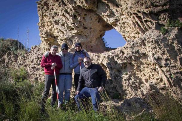 The team of researchers by the newly discovered calendar rock in Sicily. 
