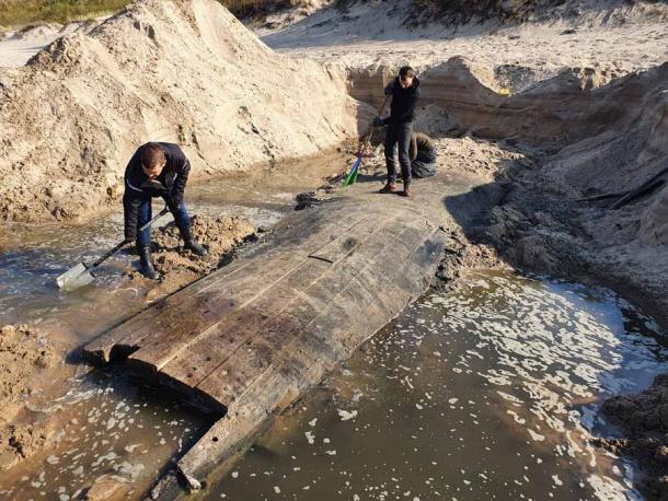 The remains of the oak timber Latvian shipwreck found near Riga is it emerged from the beach where it was discovered. (Rigas Brivosta)