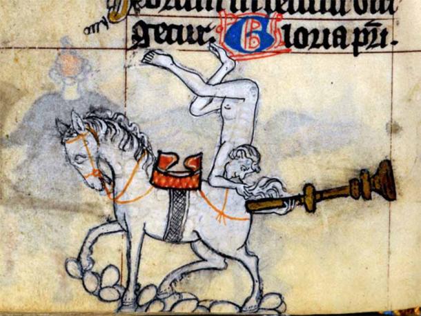 A man puts a trumpet on the back of a horse.  Unknown manuscript.