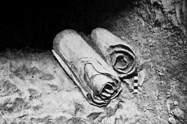 Two scrolls from the Dead Sea Scrolls lie at their location in the Qumran Caves before being removed for scholarly examination by archaeologists