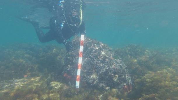 A diver from the underwater archaeology expedition shows one of the stone blocks that made up the outer wall of the sunken fortress on what is today St. Thomas Island off the coast of Bulgaria’s Primorsko.