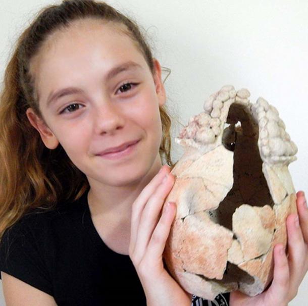 A volunteer holding the vessel