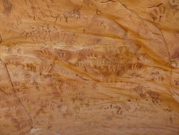 The walls of Wadi Sura II are covered with hundreds of hand stencils, images of people, wild animals and strange headless beasts.