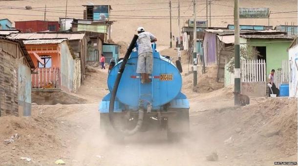 Paying for water delivered by truck is part of the daily routine for many inhabitants in Peru.