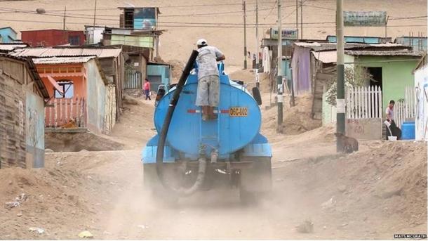 Paying for water delivered by truck is part of the daily routine for many inhabitants in Peru.
