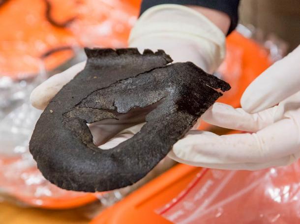 This worn-out sole tells archaeologists that the owner was willing to pay to repair his shoes, since the front of the sole is clearly cut off. The size of the heel suggests the owner was probably male and had fairly large feet. 