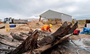 Archaeologist records the Elizabethan era ship’s remains on-site. Source: Wessex Archaeology