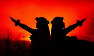 Hawaiian girls dancing in front of volcano (Julia Held/ Adobe Stock)