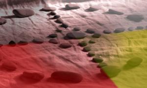 Stones arranged into a Native American medicine wheel pattern.