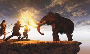 Prehistoric men hunting a young mammoth