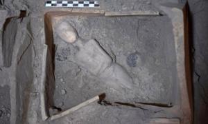 Marble protocycladic female figurine, placed diagonally at the bottom of the shrine covered by an ancient volcanic eruption.