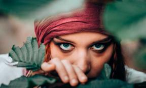 Female pirate close up looking through trees. Representative of Anne Bonny. Source: stivog / Adobe Stock