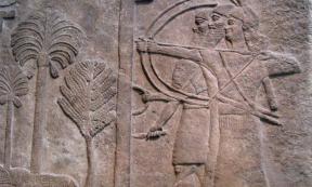 Relief, circa 728 B.C., depicting an Assyrian warrior holding a large shield to protect two archers taking aim, from the Central Palace in Nimrud and now in the British Museum, London. 