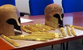 Some of the orichalcum ingots and the two Corinthian helmets found near a 2,600-year-old shipwreck off the coast of Sicily. 