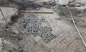 Tile floor patched with cow bones, found during excavations in Alkmaar city center.