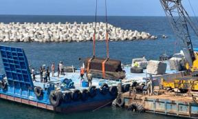 Huge stone blocks from the Lighthouse of Alexandria lifted from the seabed to platforms at Alexanfria harbor.