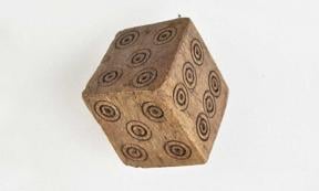This Medieval dice has two 4's and two 5's but no 1 or 2. Archaeologists believe that it was likely used to cheat while gambling. This photo shows the two 5's. 