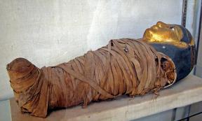Mummy of a child with a gilded face mask. Greco-Roman Museum, Alexandria, Egypt. Representational image only.
