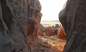 Man-made holes visible amongst the natural erosion features of the granite rock in Sudan 