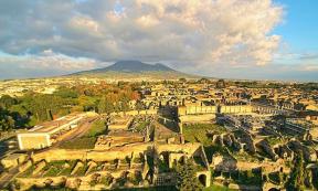 Ruins of Pompeii seen from the above with a drone, with the Vesuvius in the background 