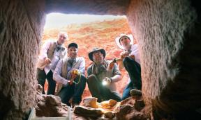 Josh Gates and the team at the entrance of the tomb found at Petra.