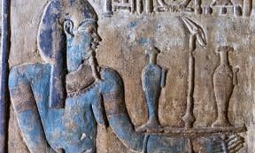 Example of the colorful paintings after the restoration: Nile god with further painted details (jewelry, pupil) and flowers painted on the offering tray. 