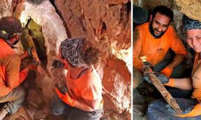 Archaeologists Oriya Amichay and Hagay Hamer removing one of the Roman swords from the crevice where they were hidden. Source: Amir Ganor/Israel Antiquities Authority