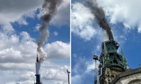 Tower of Rouen Cathedral billows smoke.