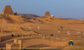 Locals on camels near Meroe pyramids, Sudan (Matyas Rehak/ Adobe Stock)