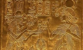 Scene from gilded shrine of Tutankhamen showing him and his wife Queen Ankhesenamun. Queen hols a sistrum and menat. 