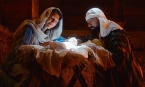 Mary and Joseph caressing baby Jesus after the virgin birth. Source: Framestock/Adobe Stock