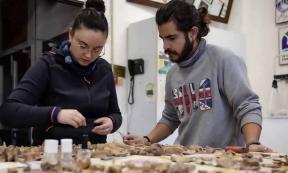 Archaeologists analyzing the remains from excavations at the Cova dels Xaragalls burial cave in Catalonia. Source: IPHES-CERCA