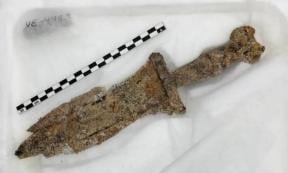 The first century BC dagger, rusted but still intact, that was removed from the back and burial of the second or third century Roman soldier.