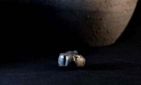 Archaeologists found a gold earring hidden inside a jar that had been placed in a wall at the Iron Age settlement called Tossal de Baltarga. 	Source: Marco Ansaloni/Frontiers