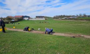 Teams of volunteers performing excavations in the rural area of Northern Ireland where the remains of the 12th century monastery have been found.