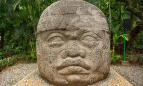 Large pre-Hispanic Olmec basalt carved head in the La Venta archeological park in Villahermosa Mexico.	Source: Barna Tanko