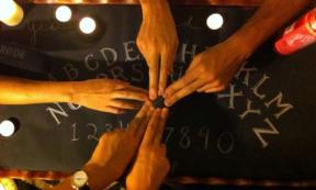 People using a Ouija board