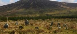 Prehistoric Irish monuments of Late Bronze Age stone circle at Boleycarrigeen, with Keadeen cursus near the summit of the mountain in the background        Source: J. O’Driscoll/Antiquity