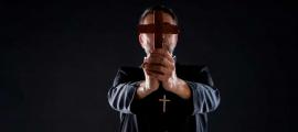 Priest conducting an exorcism. Source:  lunamarina / Adobe Stock