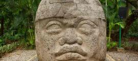 Large pre-Hispanic Olmec basalt carved head in the La Venta archeological park in Villahermosa Mexico.	Source: Barna Tanko