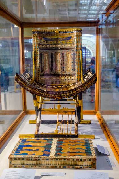 An ornate golden throne and footrest from Tutankhamun’s tomb (Mirko / Adobe Stock)